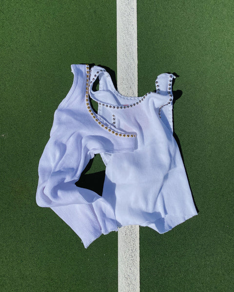 White studded tank top on tennis court